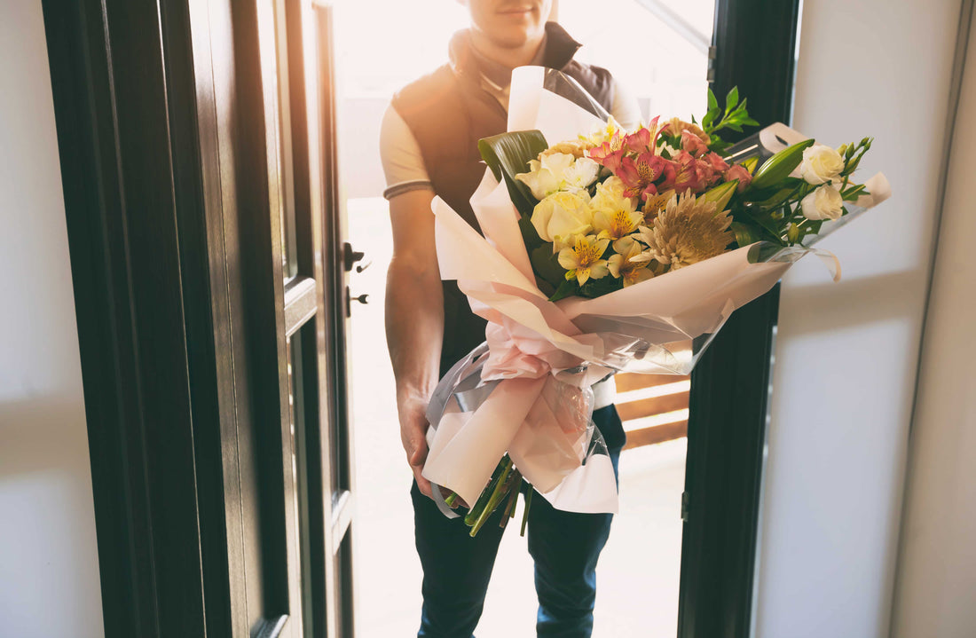 Courier delivering same-day flower bouquet in NYC with fresh roses and gift wrap