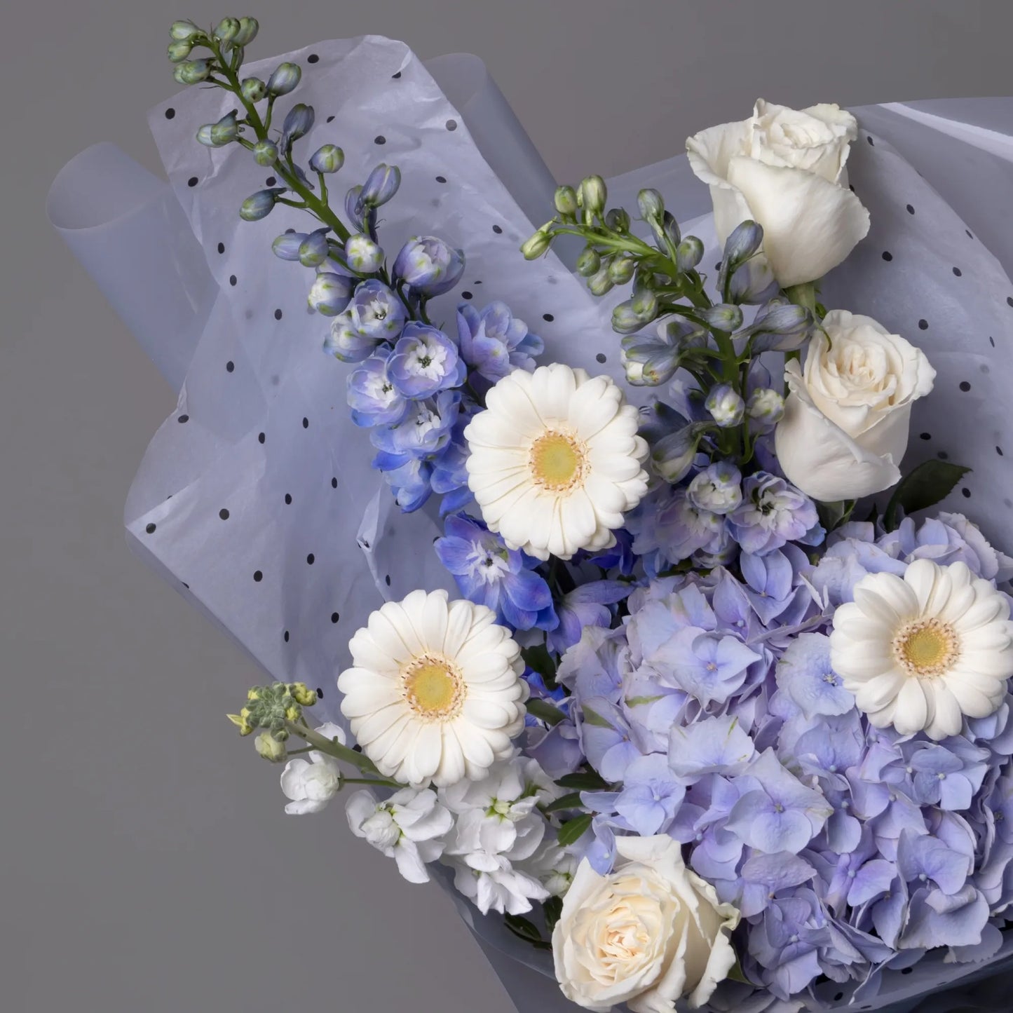 Close-up of blue hydrangea with pastel flowers in elegant bouquet