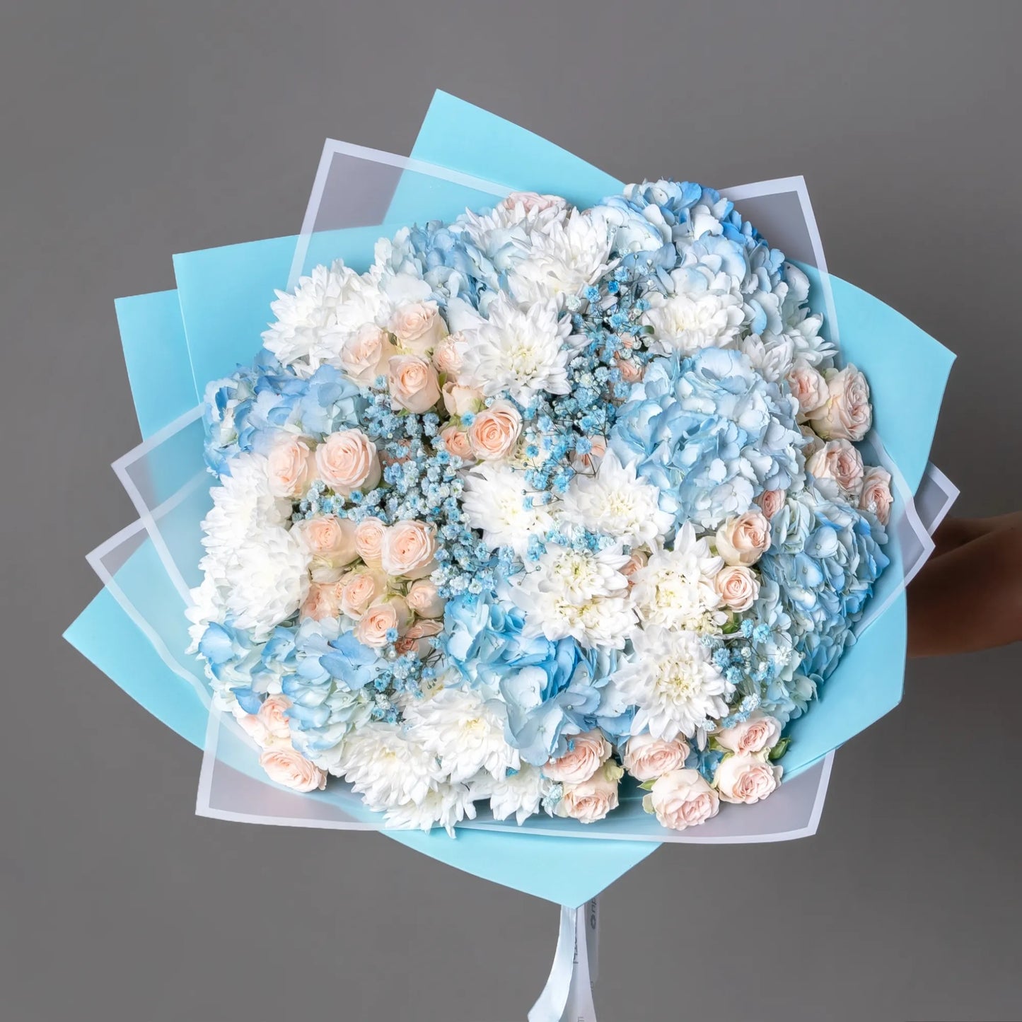 Blue hydrangea bouquet with spray roses, chrysanthemums, and gypsophila