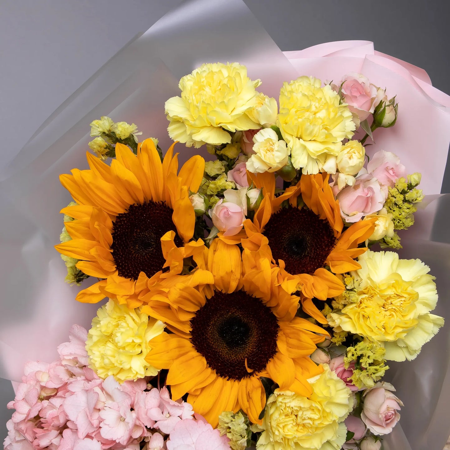 Close-up of sunflowers and hydrangea in cheerful mixed bouquet