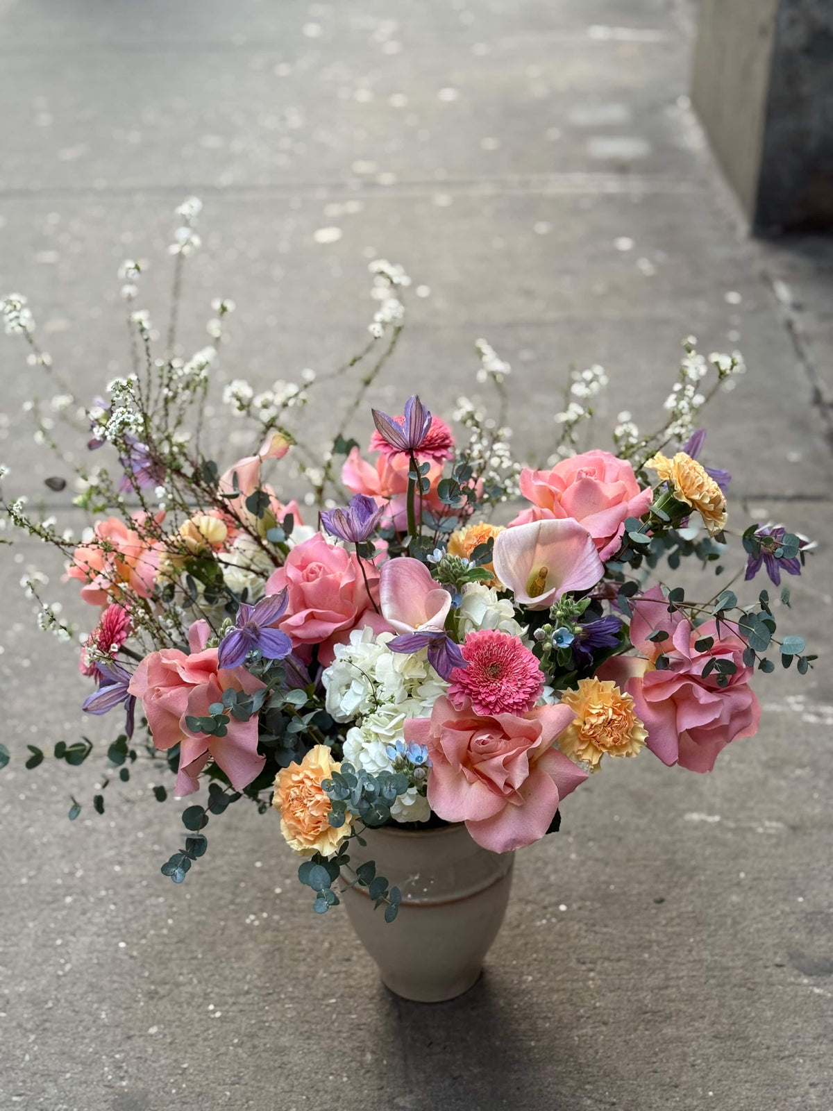 Luxury floral arrangement in vase with roses, hydrangeas and calla lilies