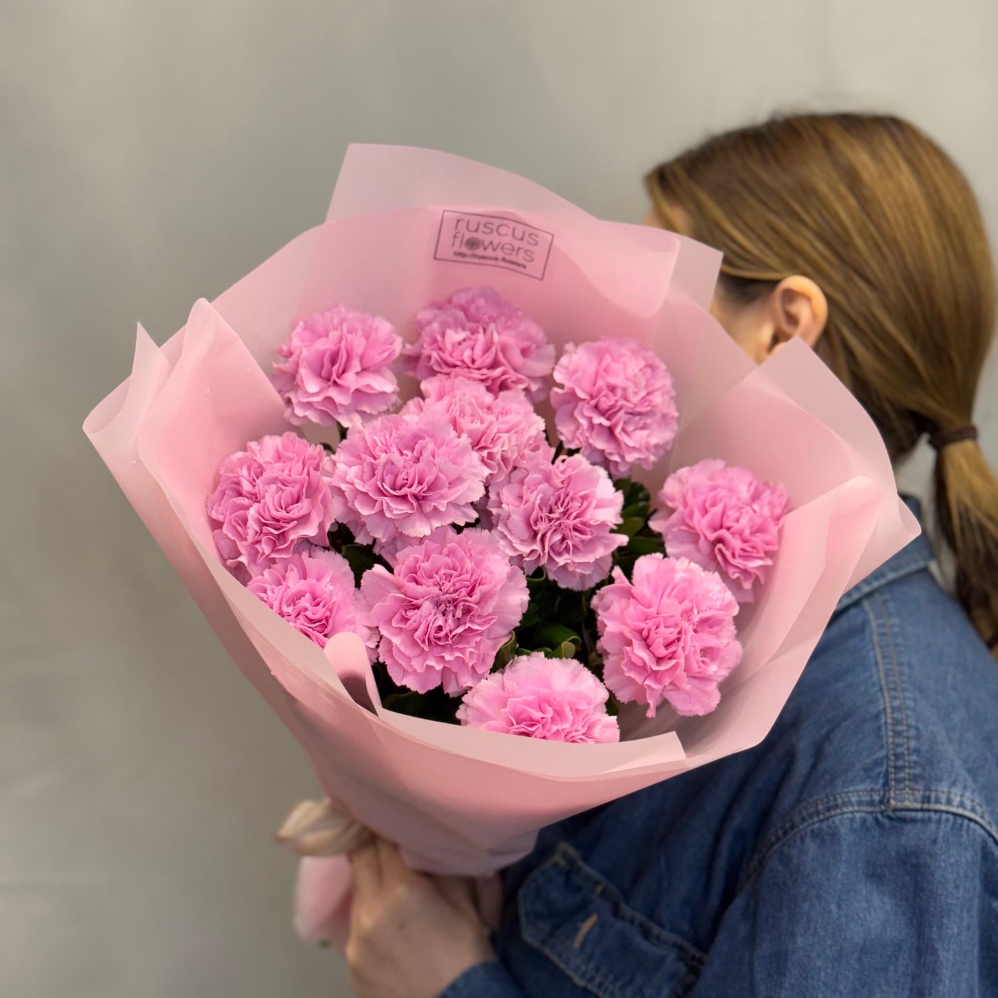Bright pink carnations in natural wrap