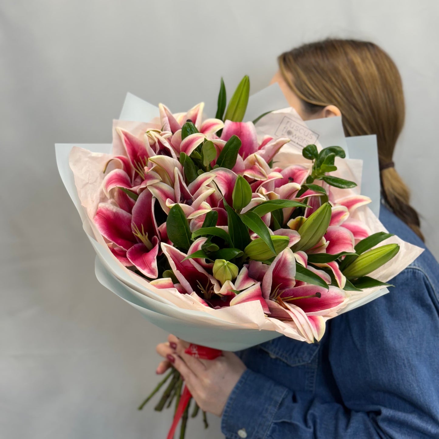 Pink lilies in a tall bouquet