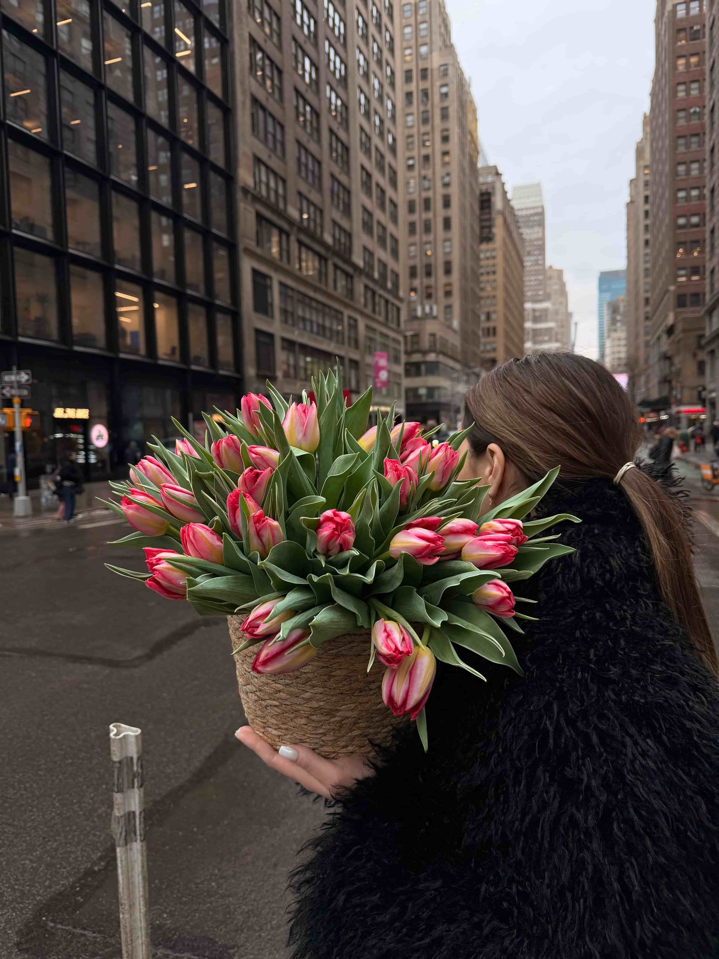 Basket with 50 pink peony tulips arranged in natural woven basket