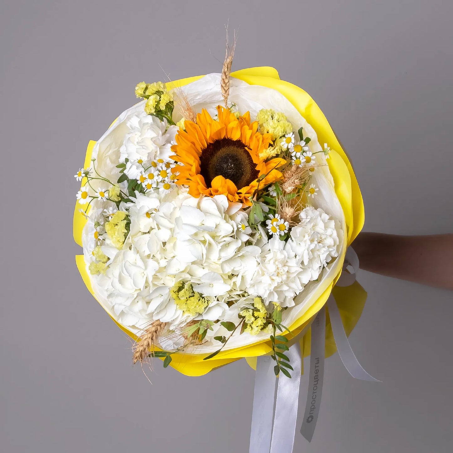 Bouquet with sunflower, white hydrangea, chamomile, and greenery