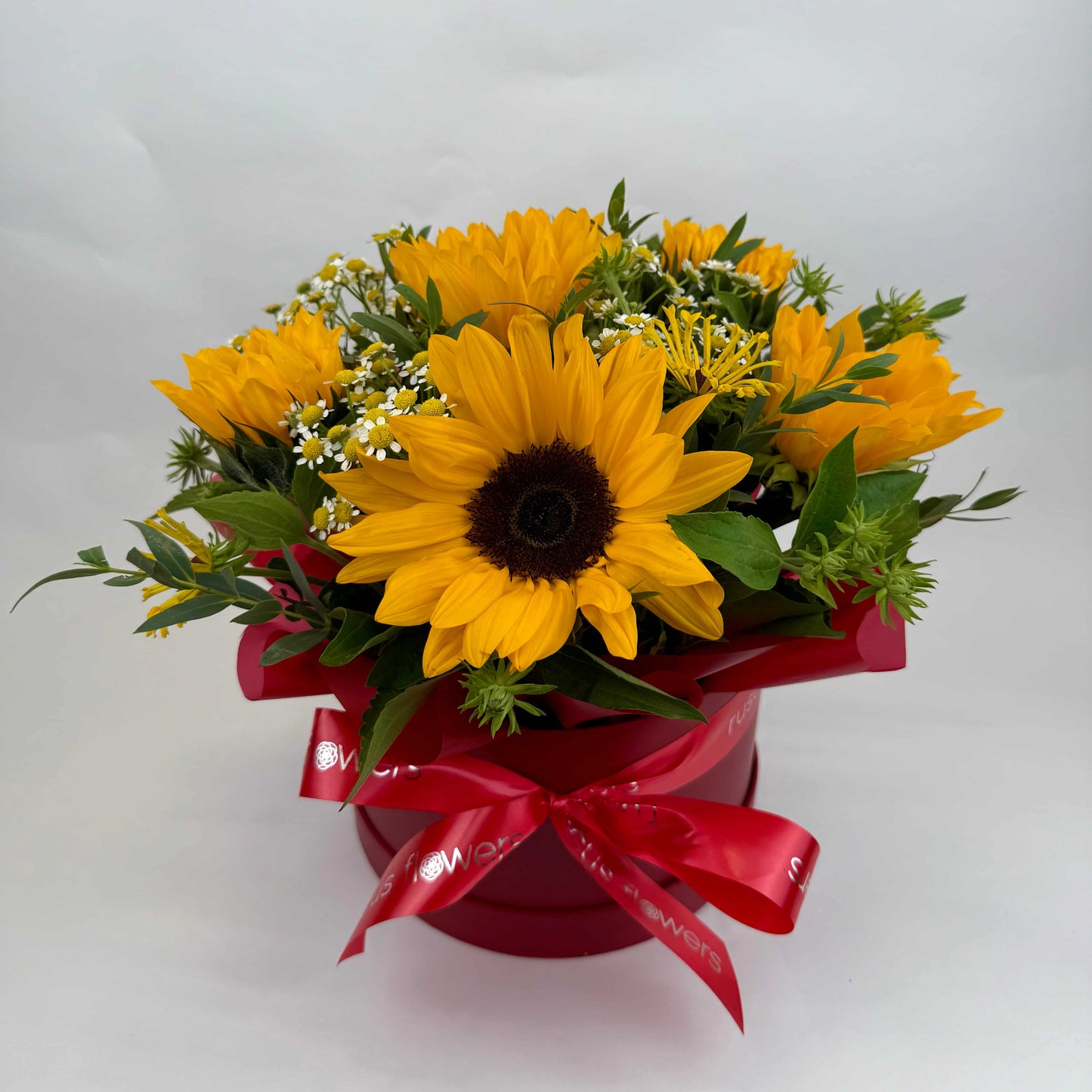 Box arrangement with sunflowers, chamomile, eucalyptus, and greenery