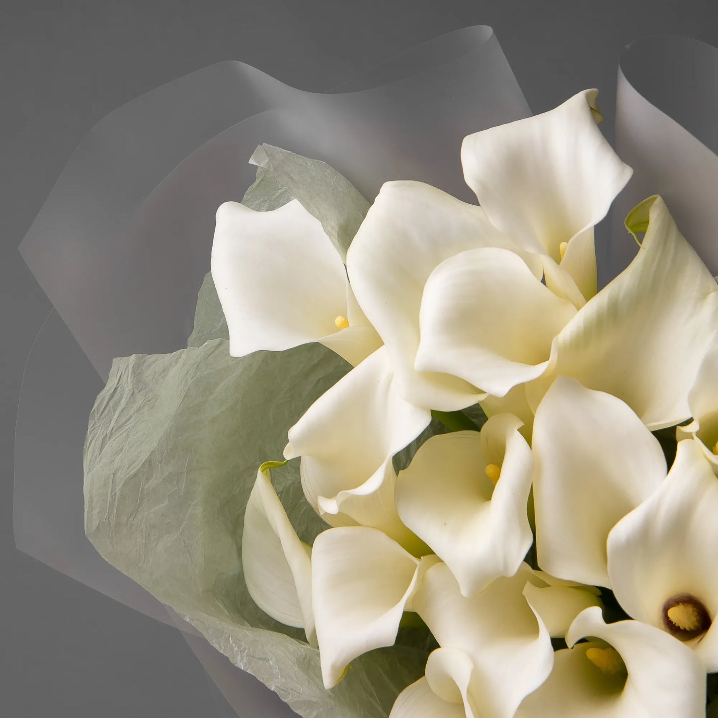 Close-up of white calla lilies in elegant bouquet