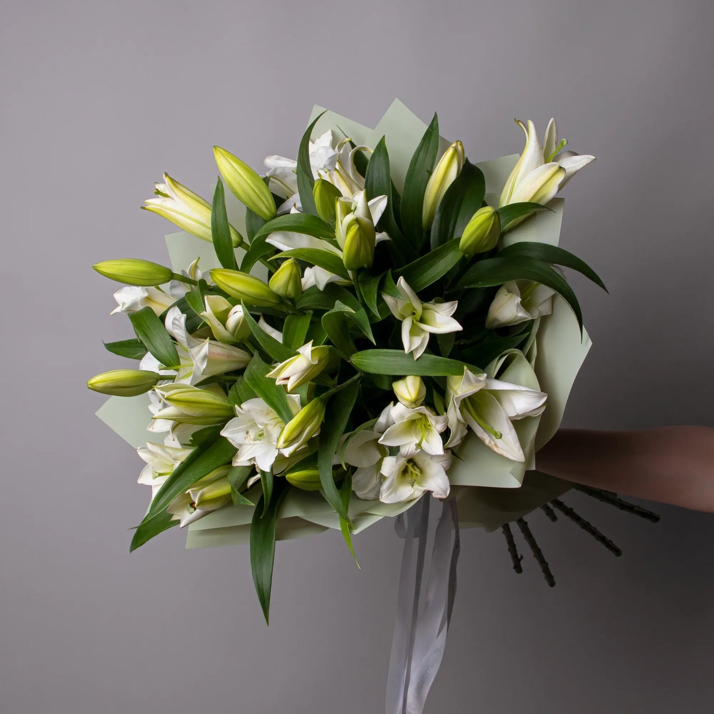 Bouquet of 8 white lilies with greenery