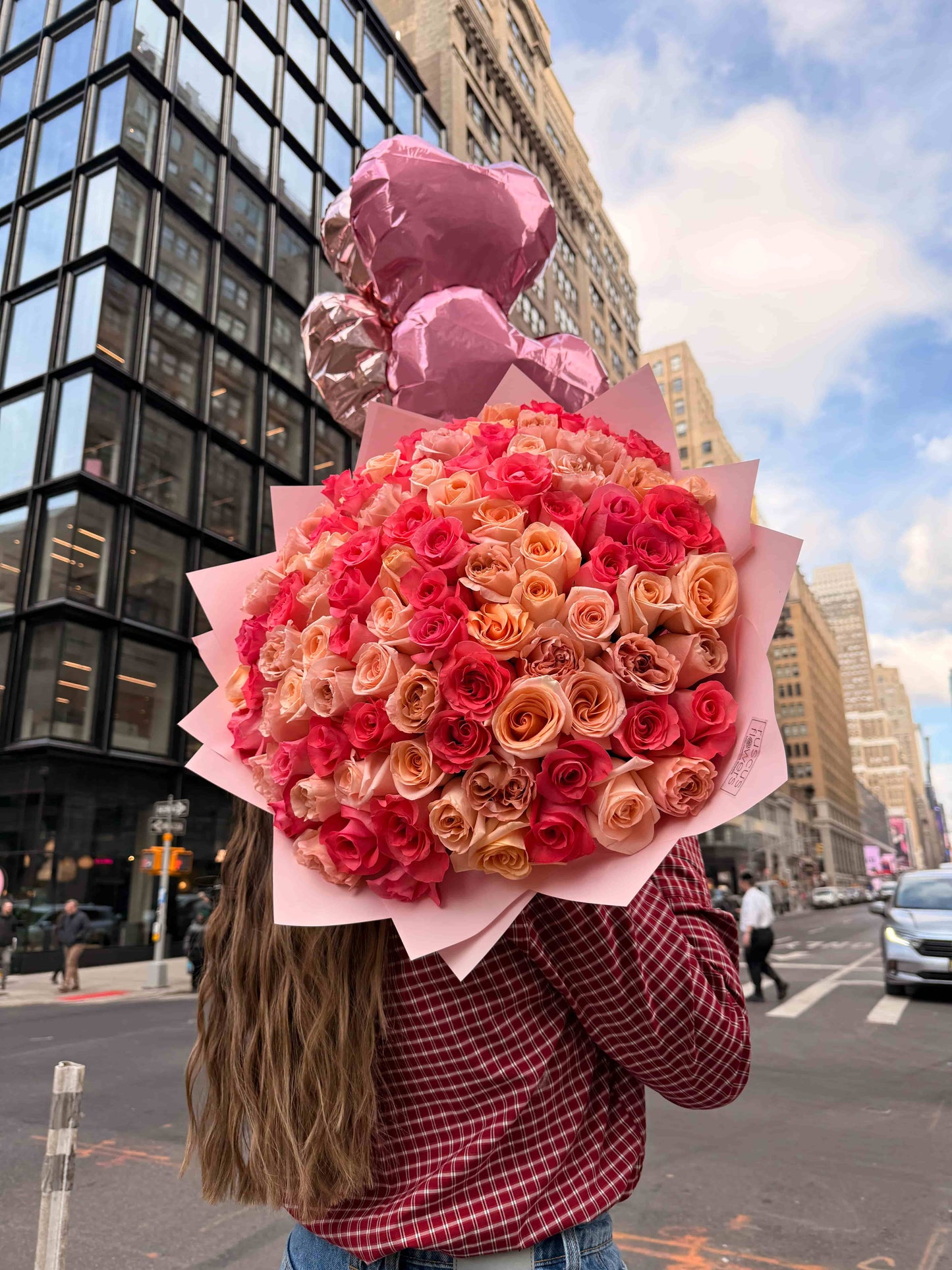 Elegant bouquet of 100 pink roses in soft wrapping