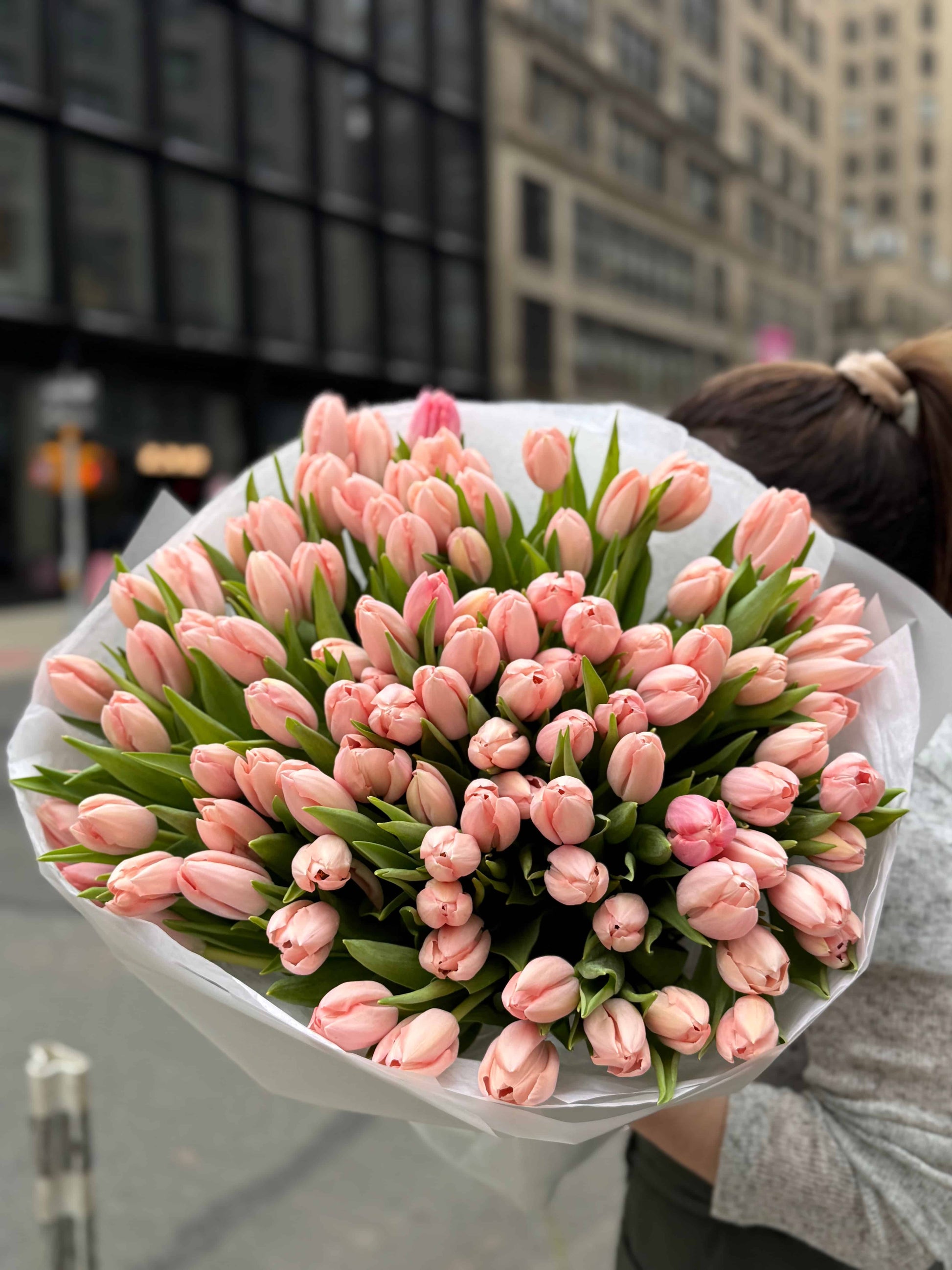 Bouquet of 100 cream tulips wrapped in soft neutral paper in NYC