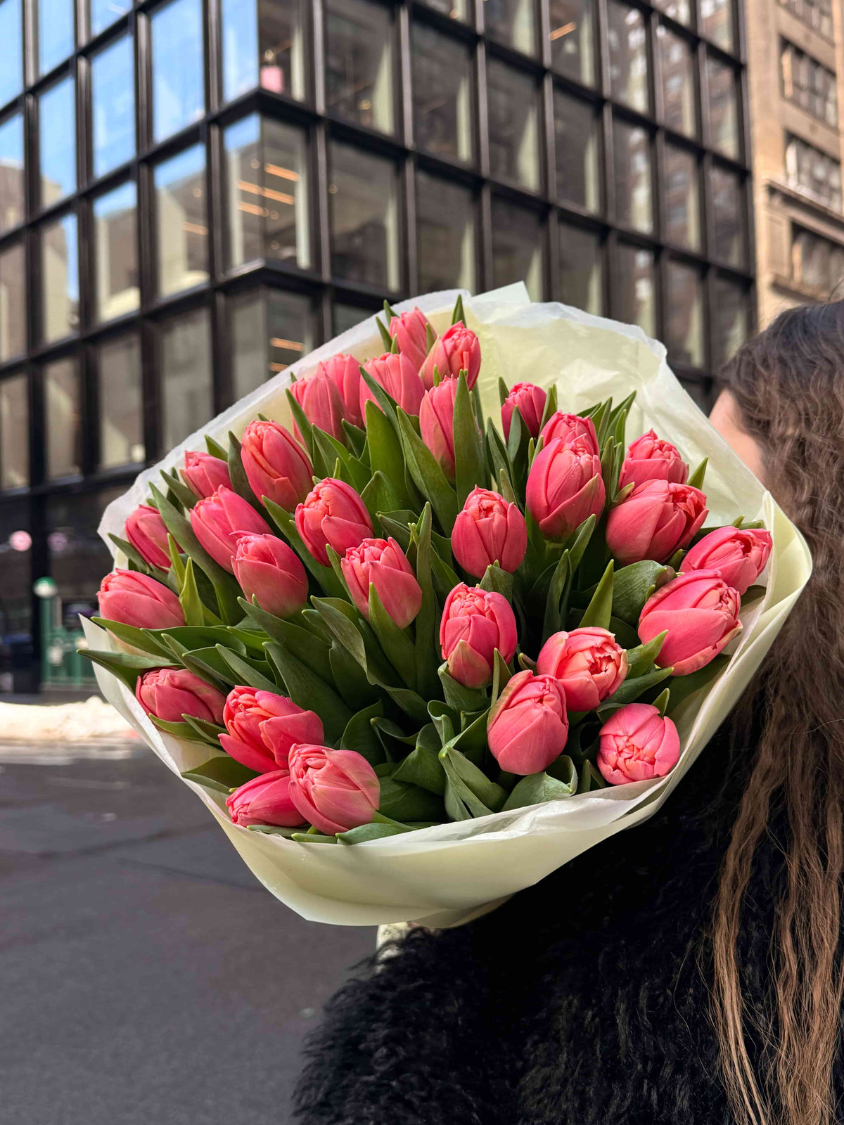 Bouquet of 30 pink peony tulips wrapped in cream paper in NYC