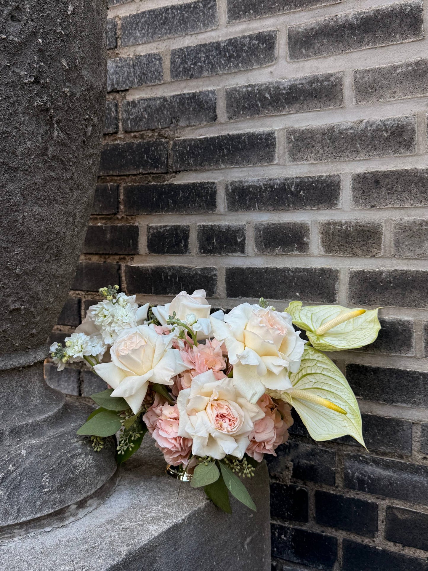 Bouquet of flowers against a brick wall