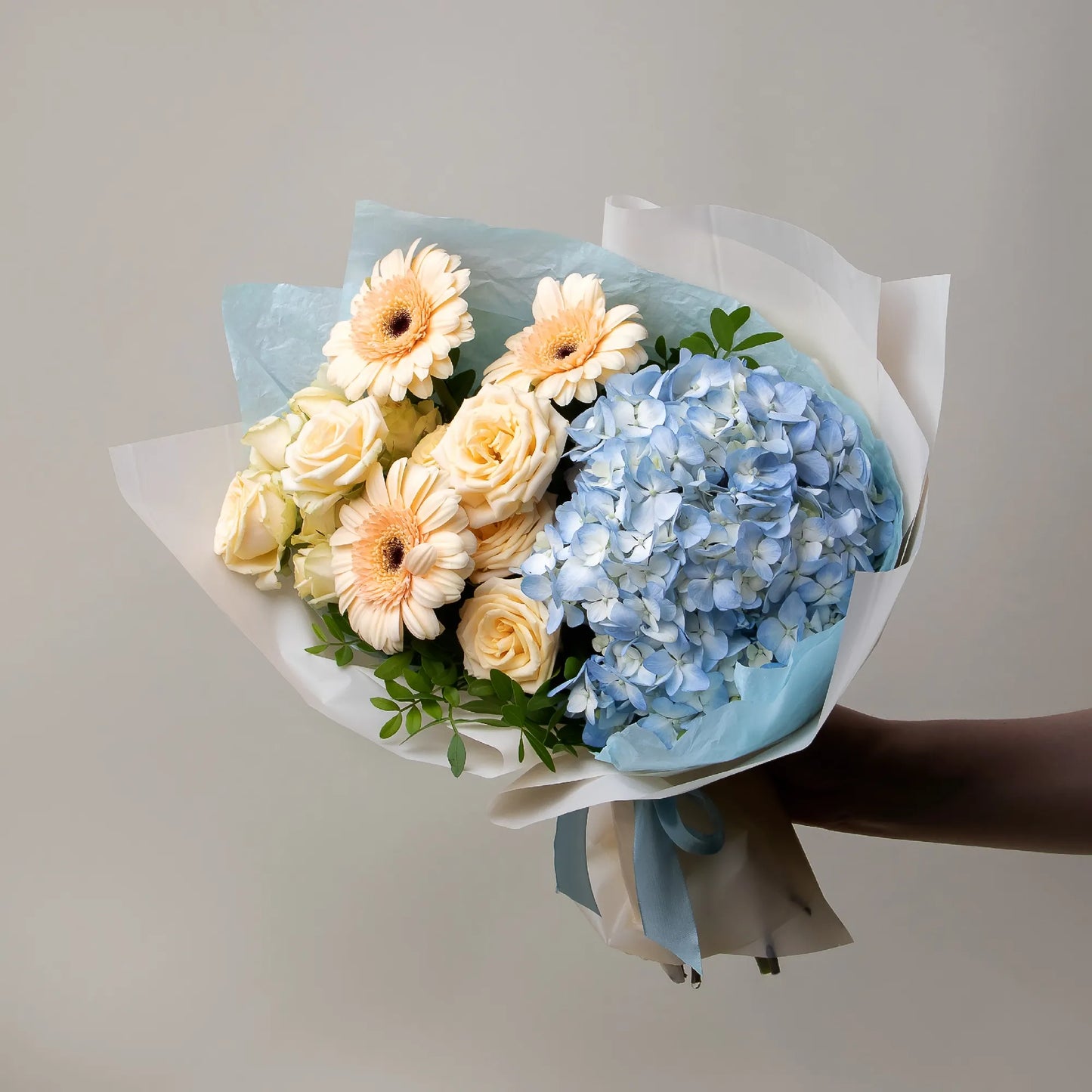 Bouquet with blue hydrangea, cream gerbera mini, and spray roses