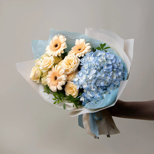 Bouquet with blue hydrangea, cream gerbera mini, and spray roses