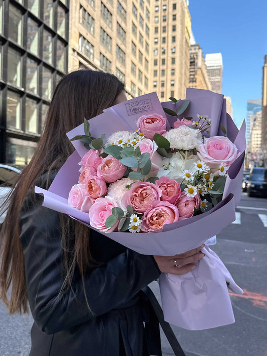 Mixed bouquet with roses, hydrangea and spray garden roses wrapped in soft paper