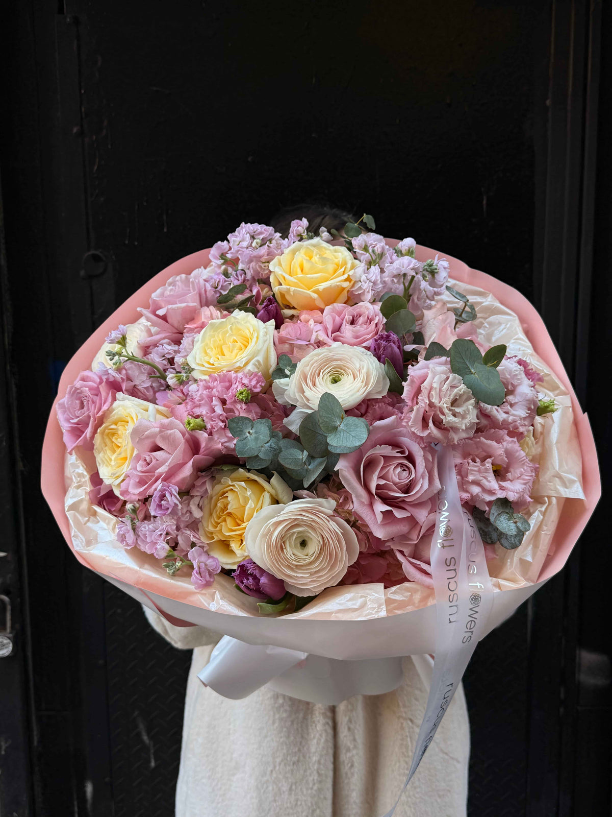 Blush bouquet with roses, hydrangeas and ranunculus in pastel wrapping