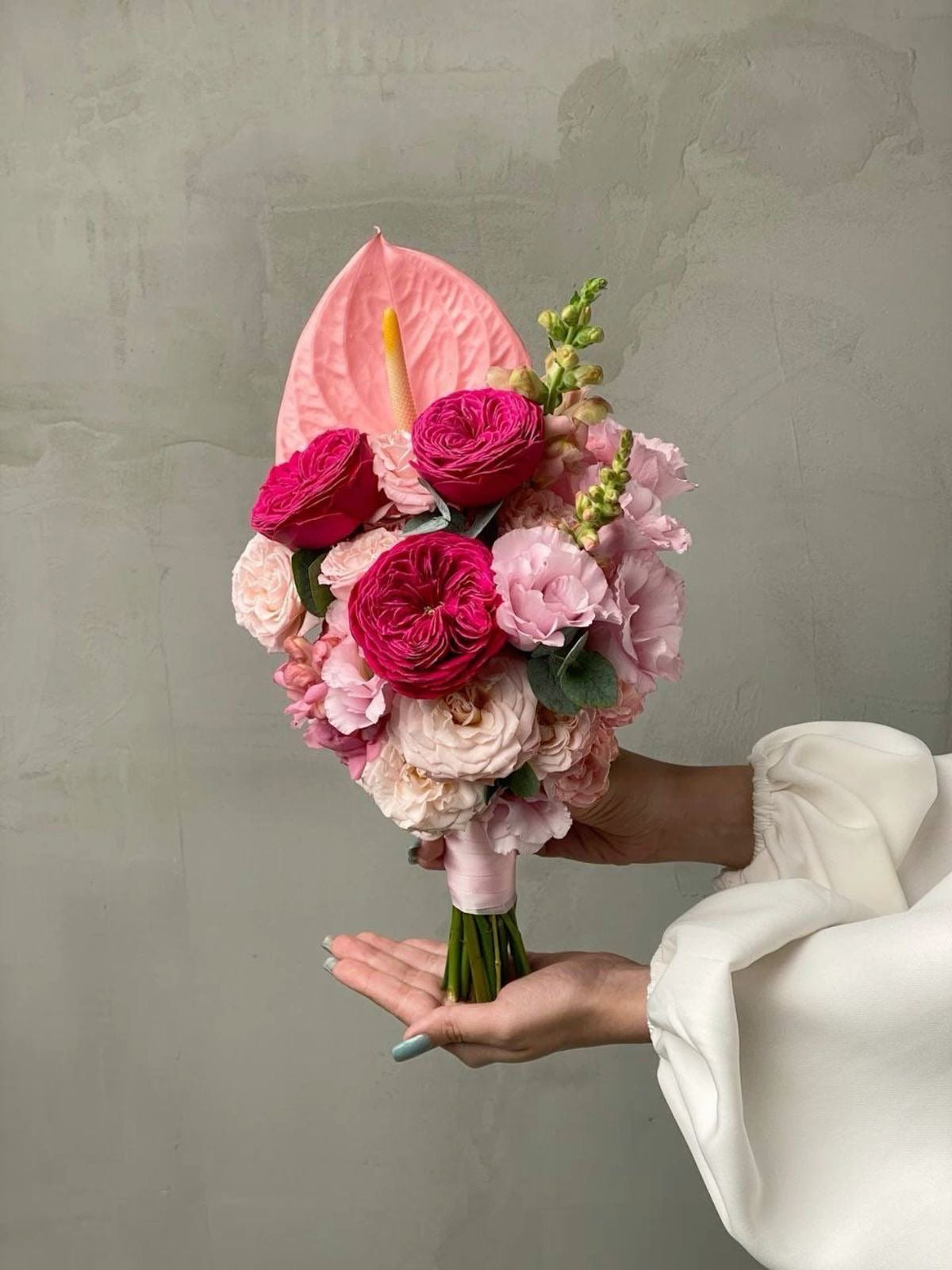 Soft bridal bouquet with blush anthurium, garden spray roses, lisianthus, and spray roses.