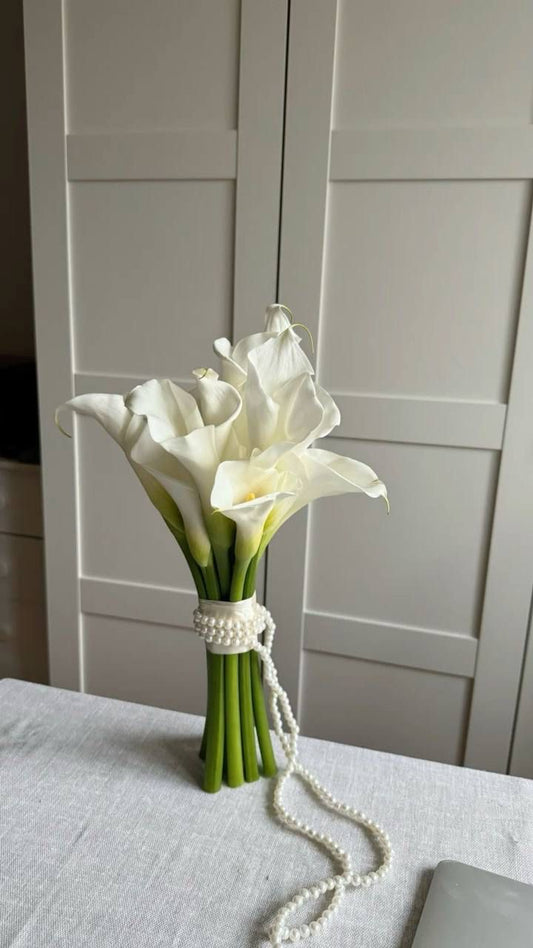 Bridal bouquet of white calla lilies wrapped with pearls
