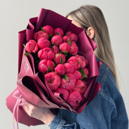 Bouquet of 26 bright peonies with greenery