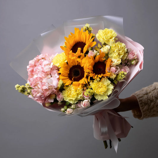 Bright bouquet with sunflowers, hydrangea, spray roses, and carnations