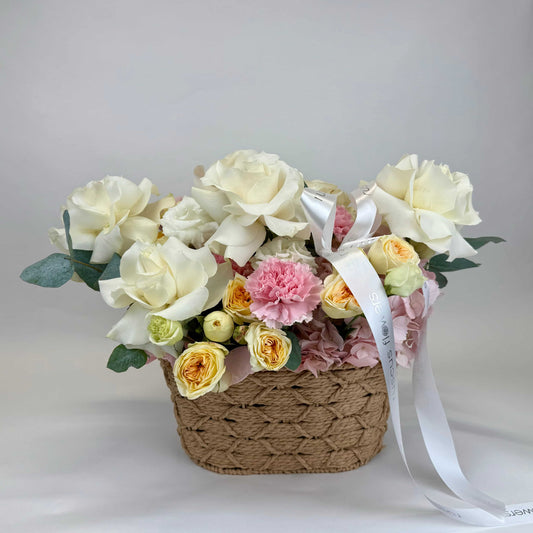 Floral basket with roses, hydrangeas, lisianthus, and carnations