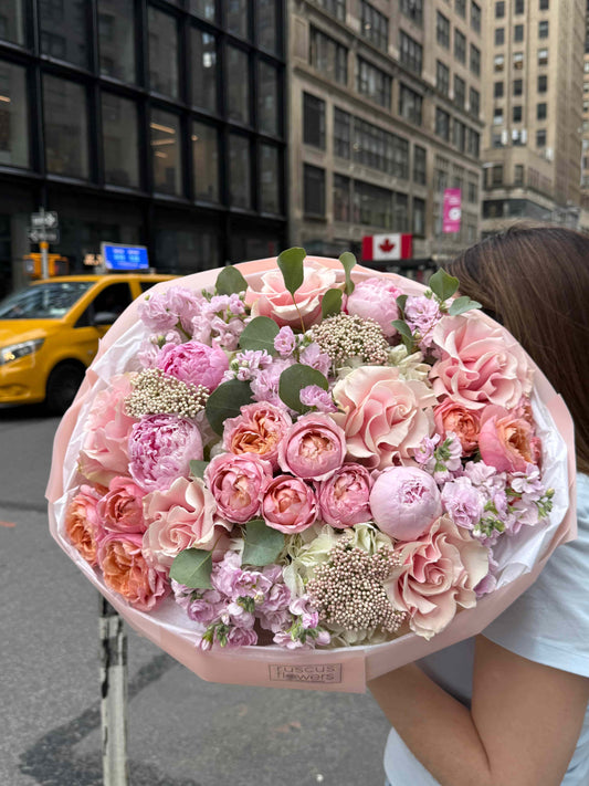 Bouquet with French roses, peonies and hydrangeas in soft garden style wrapping