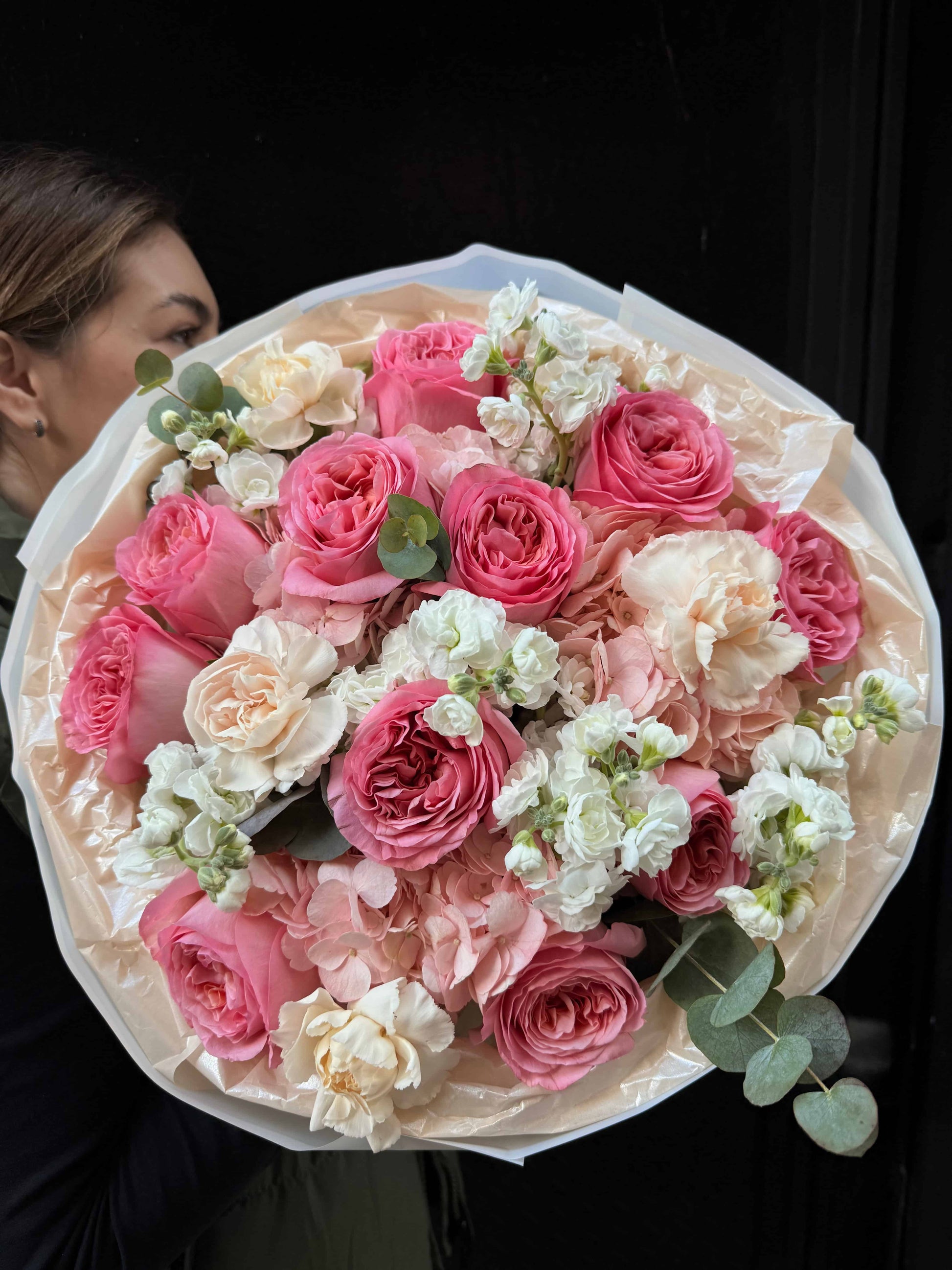 Bouquet of soft garden roses with seasonal greens