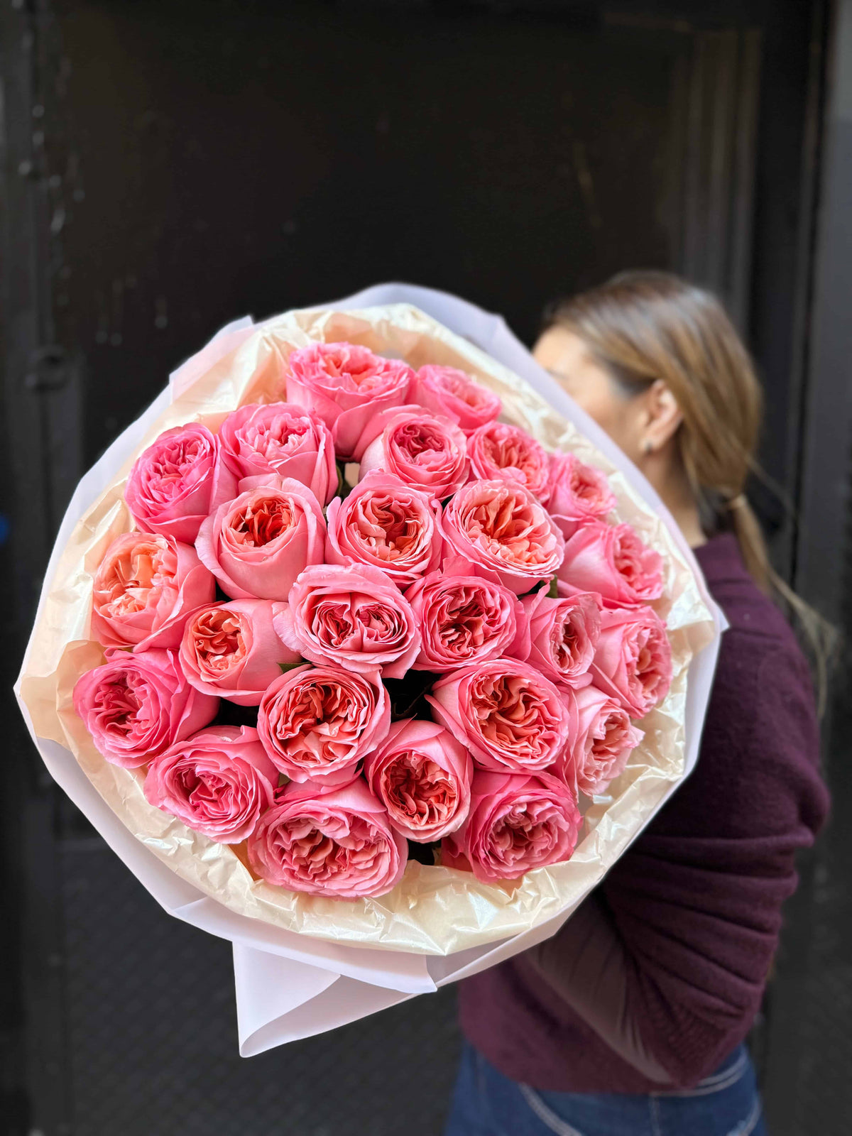 Wrapped bouquet of garden roses in blush tones