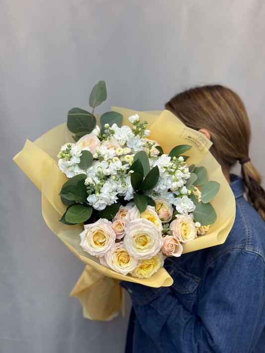Spray roses, chamomile, and eucalyptus in a garden-style bouquet
