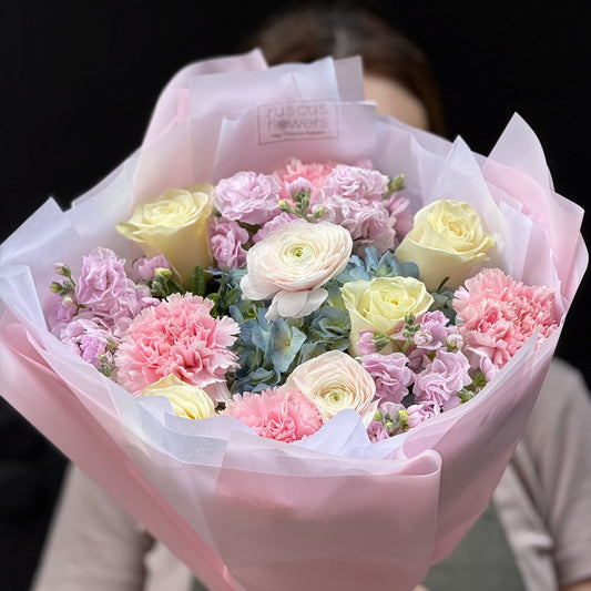 Modern bouquet with hydrangea, ranunculus, roses, carnations and stock.