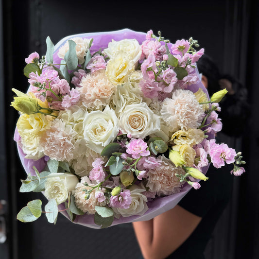 Lush blush bouquet with hydrangea, roses, carnations, lisianthus and stock.