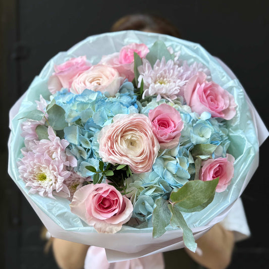 Garden bouquet with hydrangea, roses, ranunculus and chrysanthemums.