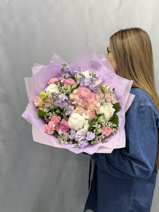 Soft pastel bouquet with peonies, ranunculus, hydrangeas, and more