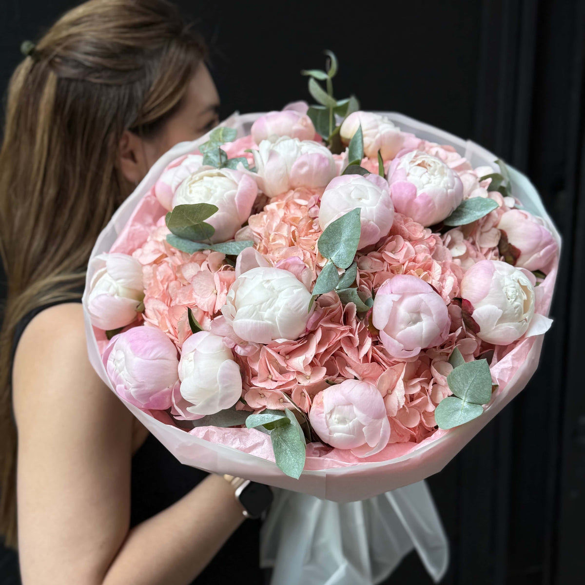 Abundant peonies and hydrangea bouquet with eucalyptus.