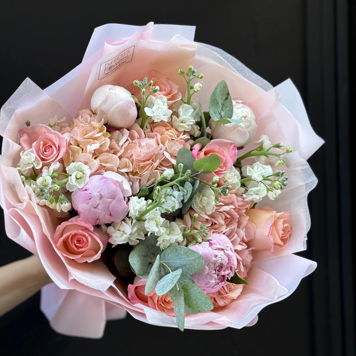 Soft pink bouquet with peonies, hydrangea, roses and stock.