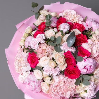 Close-up of pastel bouquet with peonies, spray roses, and hydrangeas