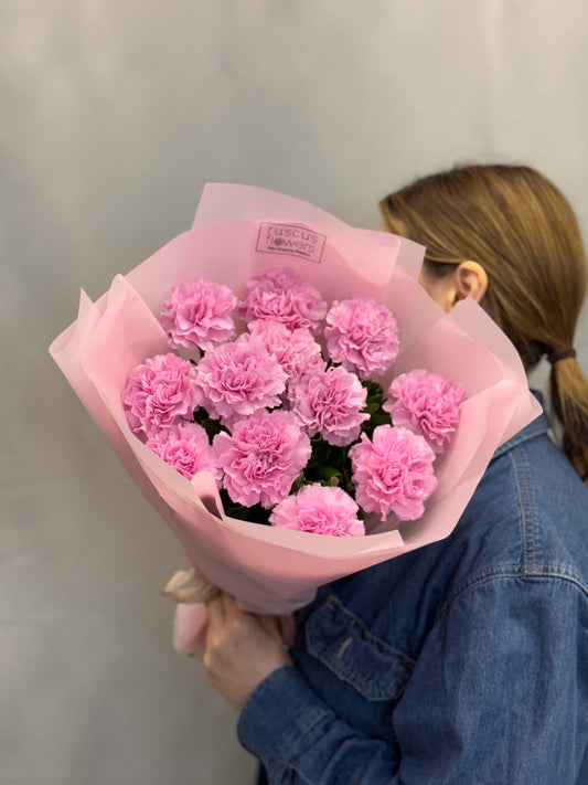 Bright pink carnations in natural wrap