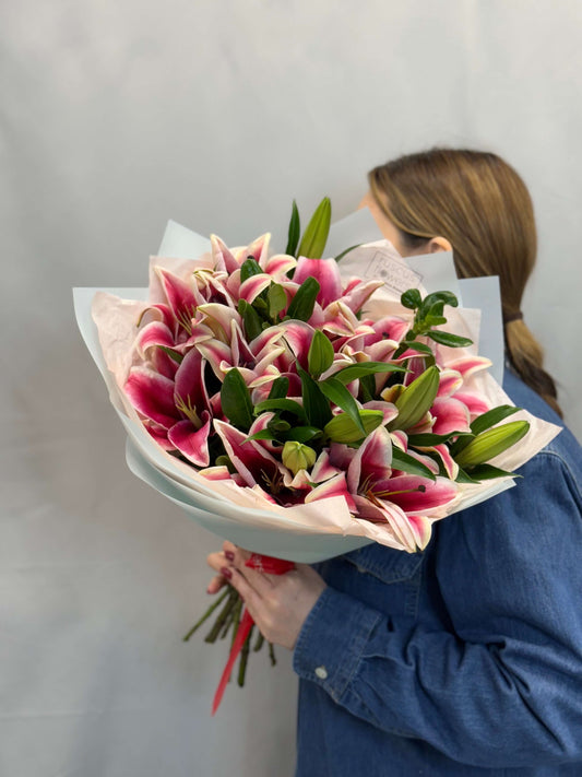 Pink lilies in a tall bouquet