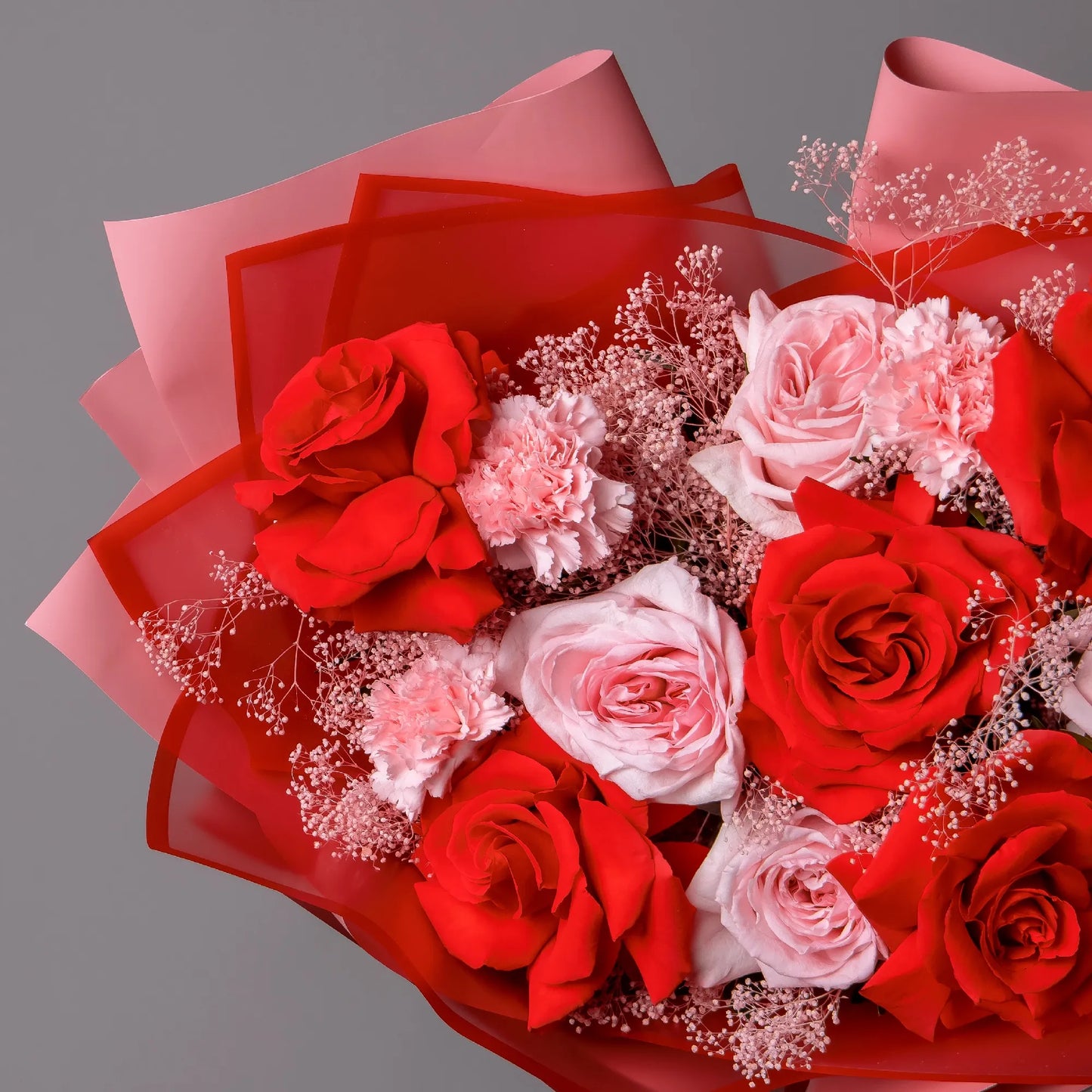 Close-up of red and garden roses in bold romantic bouquet