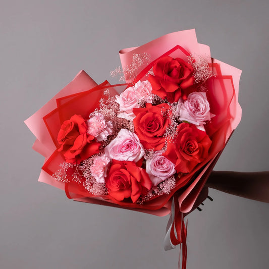 Bouquet with red roses, garden-style roses, and greenery