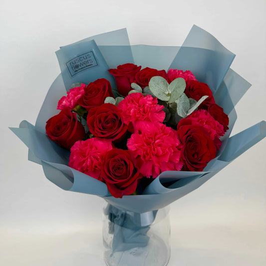 Bouquet with red roses, bright carnations, and eucalyptus