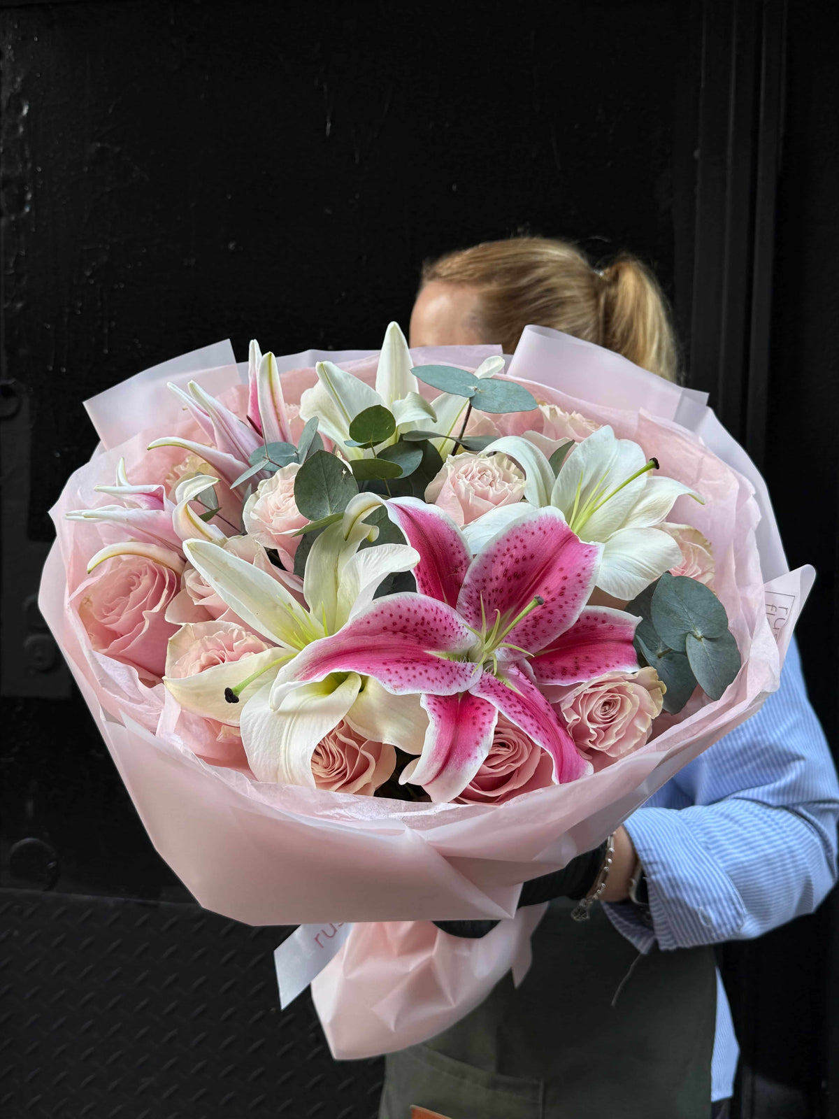 Bouquet with roses and lilies in soft elegant wrapping in NYC