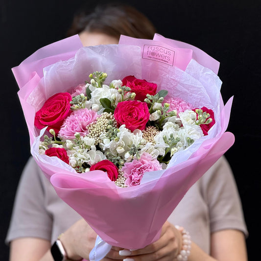 Garden bouquet of roses, stock and ozothamnus with eucalyptus.