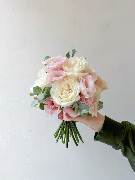 Soft, airy bridal bouquet in white and blush tones.