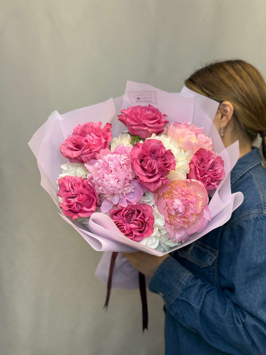 Blush peonies, hydrangeas, and garden roses with soft greenery