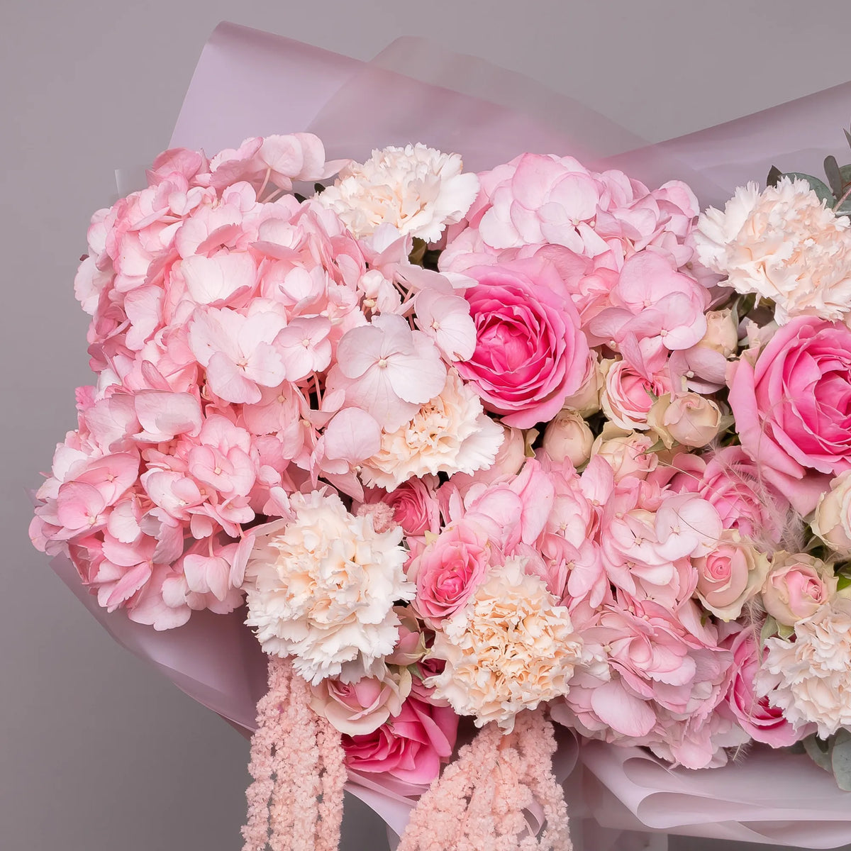 Close-up of roses, hydrangeas, and soft fillers in gentle bouquet
