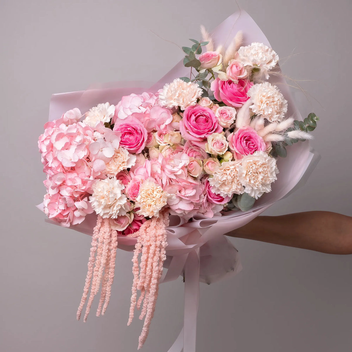 Bouquet with hydrangeas, roses, spray roses, carnations, and dried florals