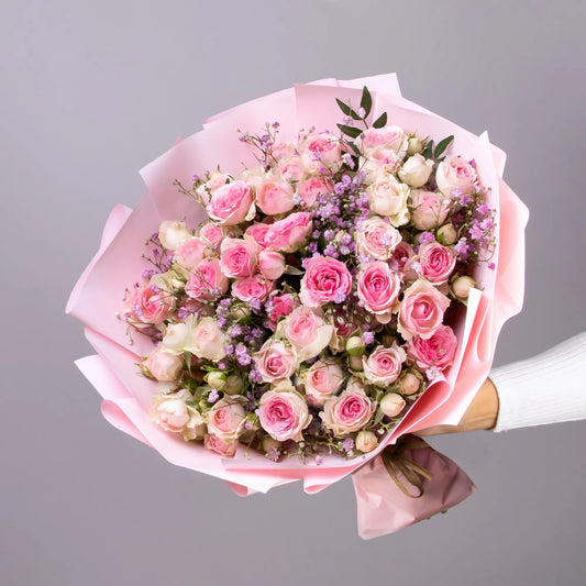 Bouquet with spray roses, gypsophila, and pistachio greenery