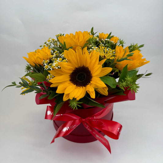 Box arrangement with sunflowers, chamomile, eucalyptus, and greenery