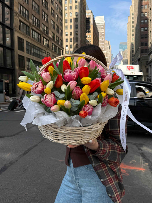 Basket with 80 tulips and eucalyptus arranged in natural woven basket